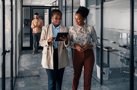 Two women working together with laptop